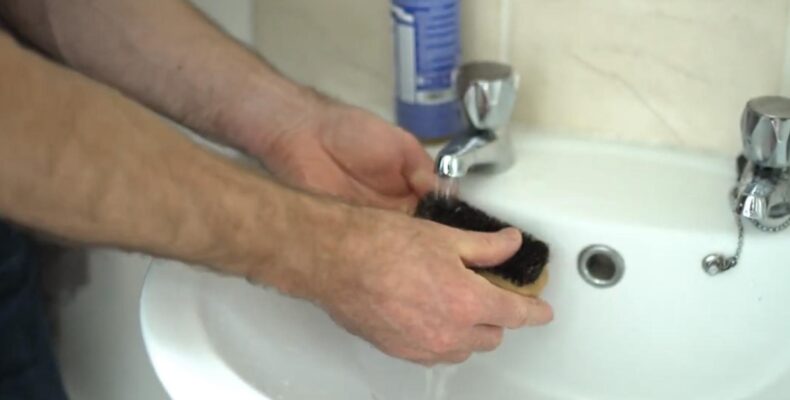 Man is cleaning the Beard Brush