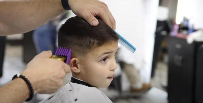 Kid getting a haircut at the barber's