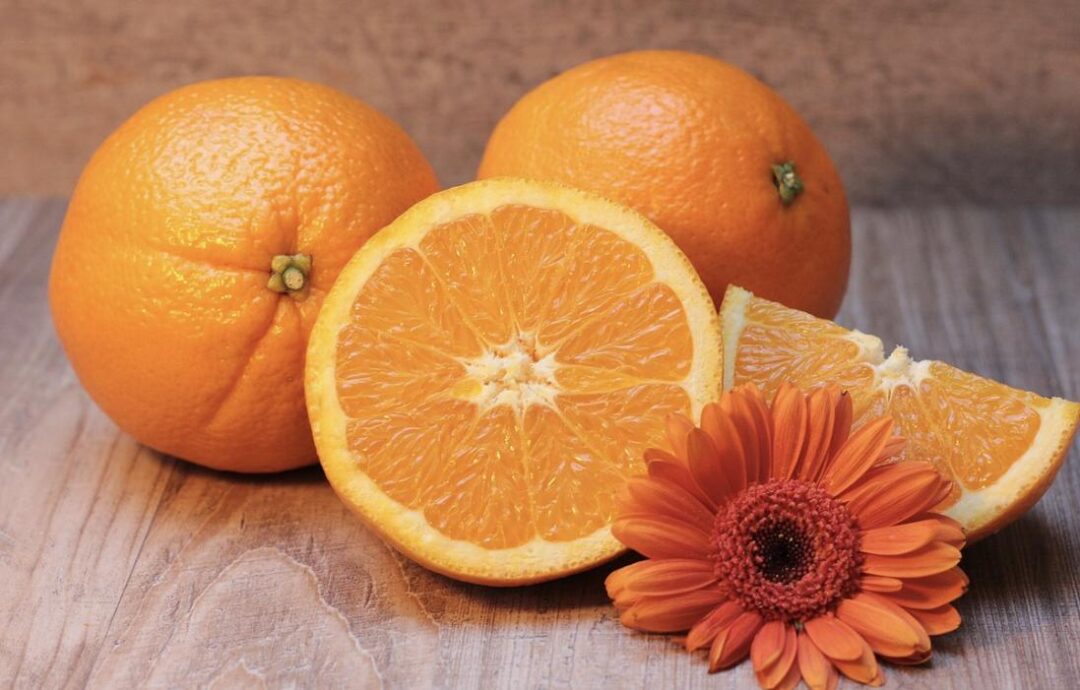 Oranges and flower on the table.