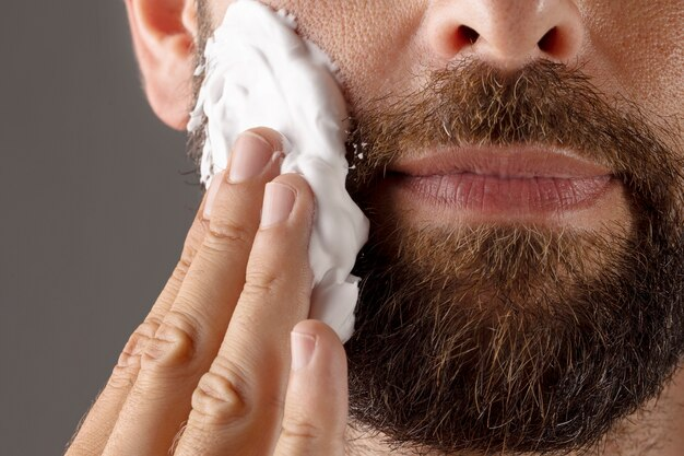Applying cream to a beard.