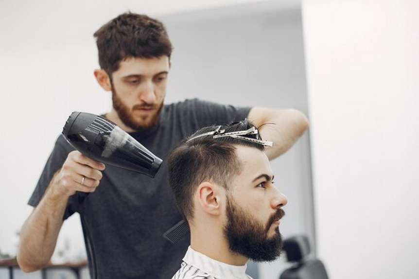 Barber using a hair blower on a client's hair
