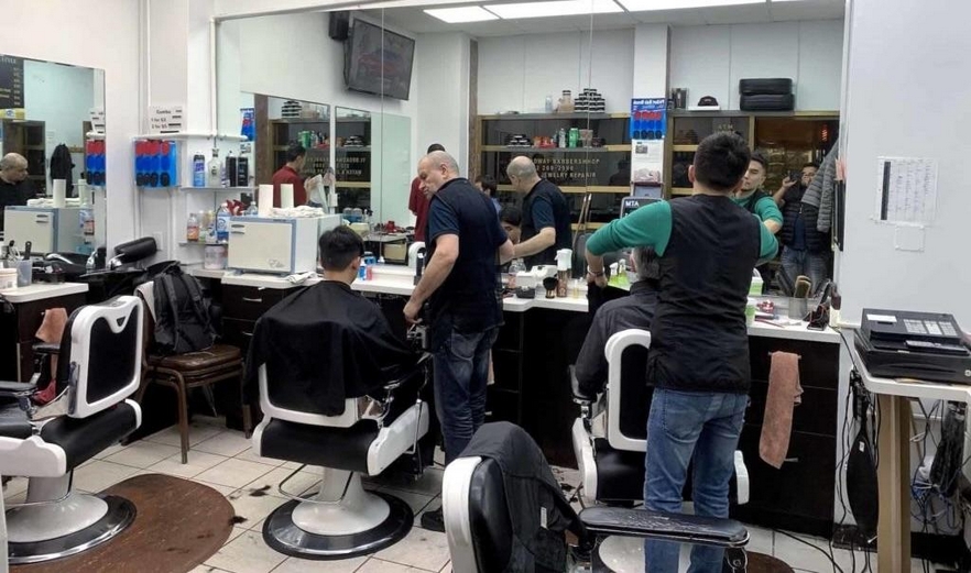 Hairdressers cutting clients' hair in a barbershop